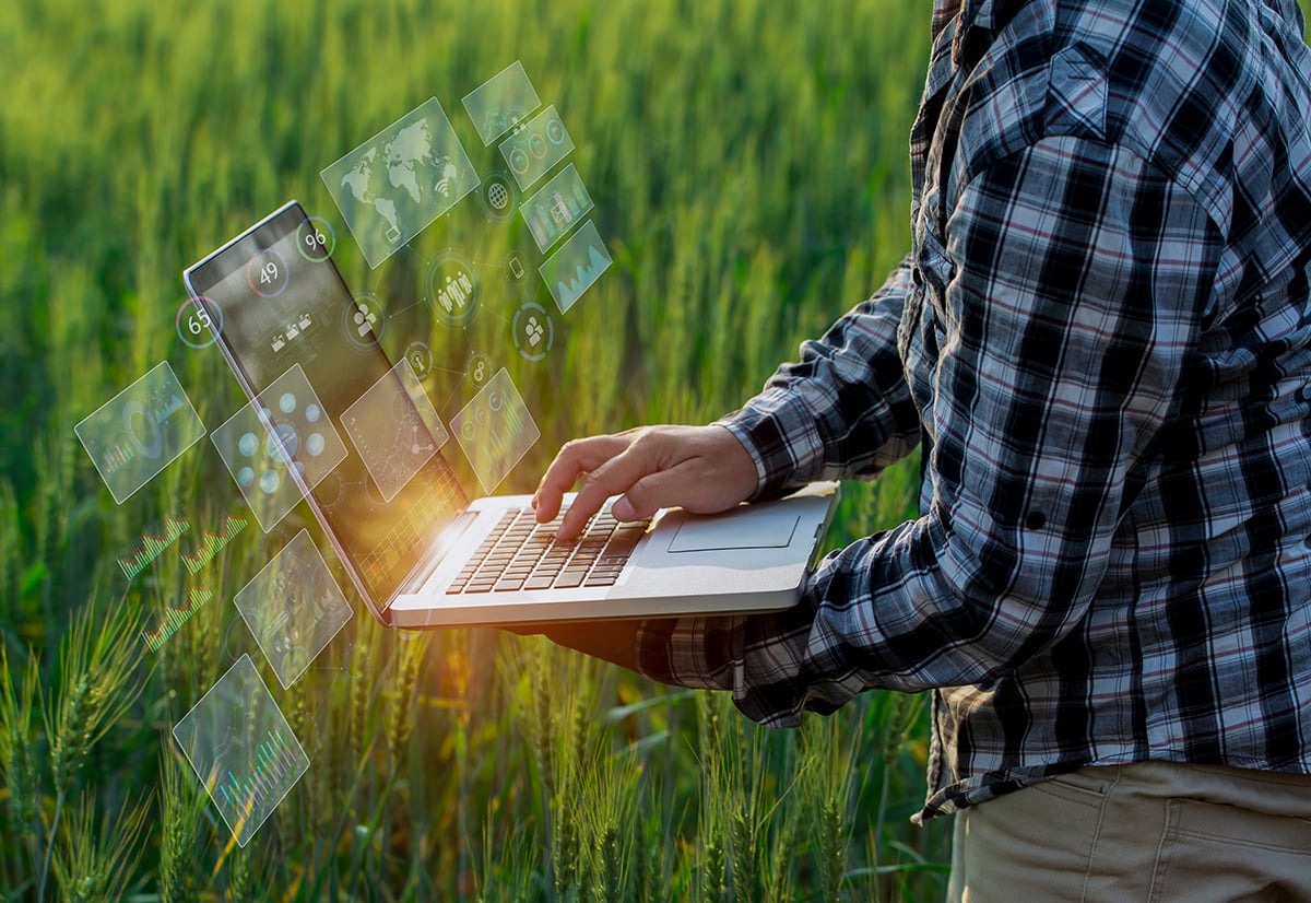 farmer-in-field-holding-laptop-with-data